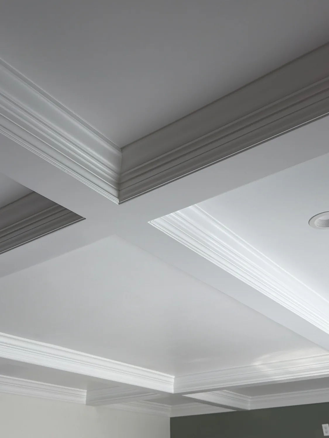 Coffered ceiling beam grid with layered crown molding profile by LM Legacy Remodeling