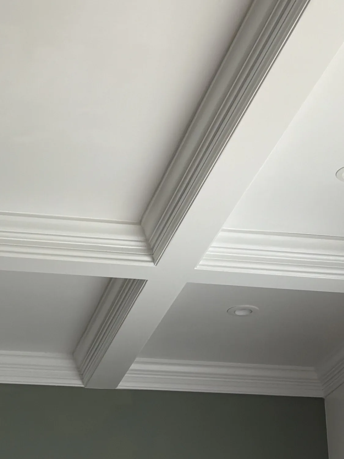 Coffered ceiling beam intersection with mitered crown returns by LM Legacy Remodeling