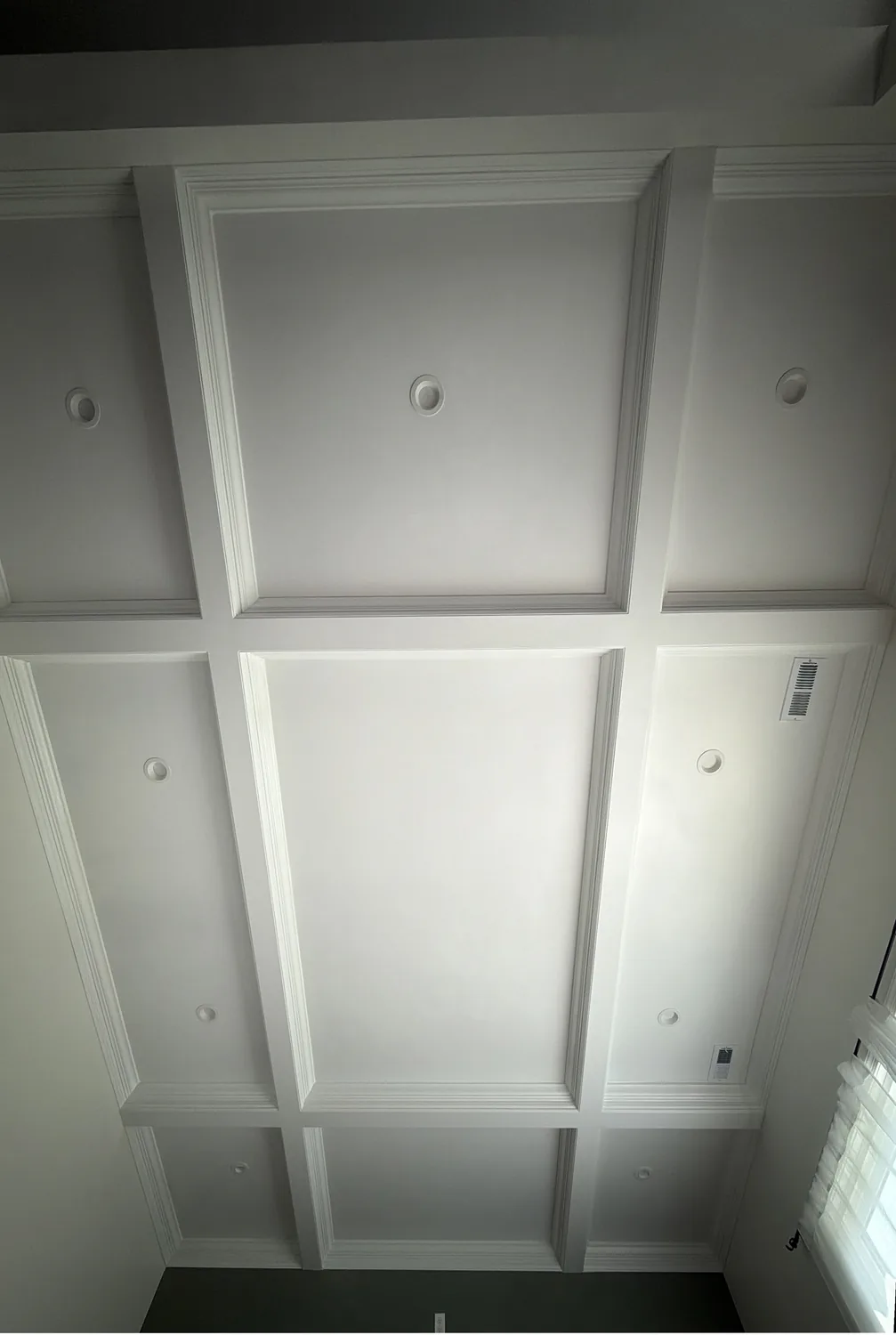 Coffered ceiling grid with recessed panels and layered crown molding by LM Legacy Remodeling