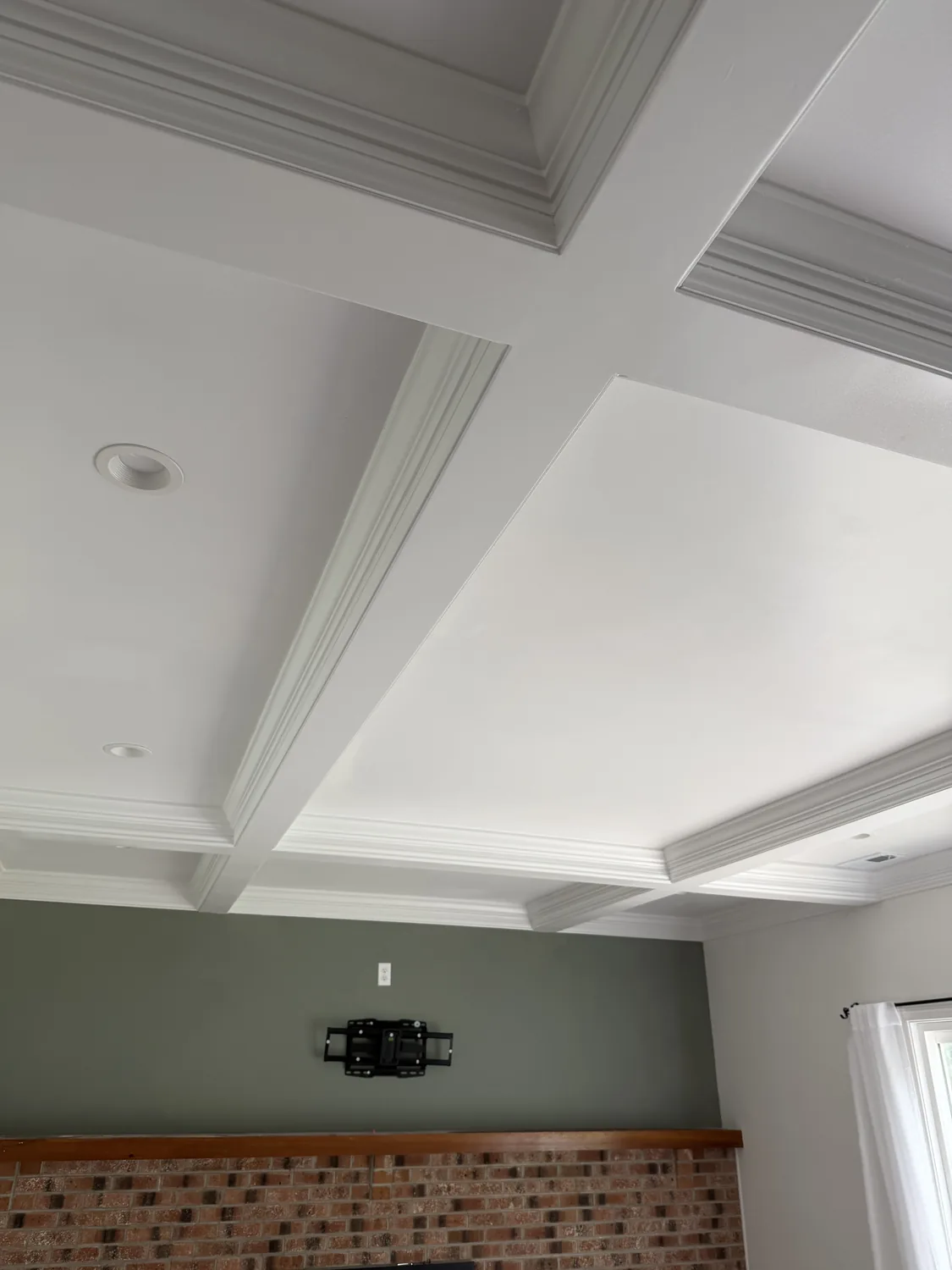 Coffered ceiling with crown-wrapped beams and recessed lighting by LM Legacy Remodeling