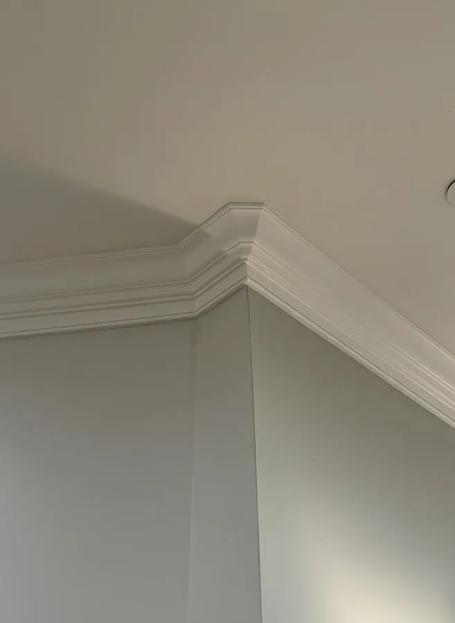 Crown molding installation in a Main Line PA living room by LM Legacy Remodeling