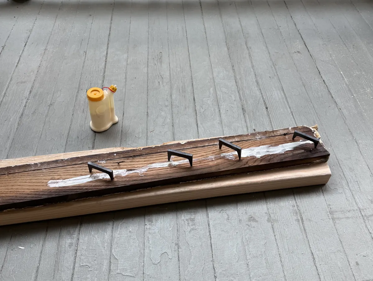 Original window trim split along the grain, glued and clamped for repair before reinstalling